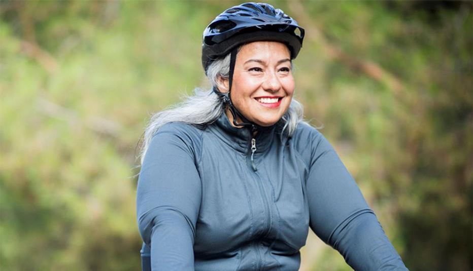 smiling woman riding a bike